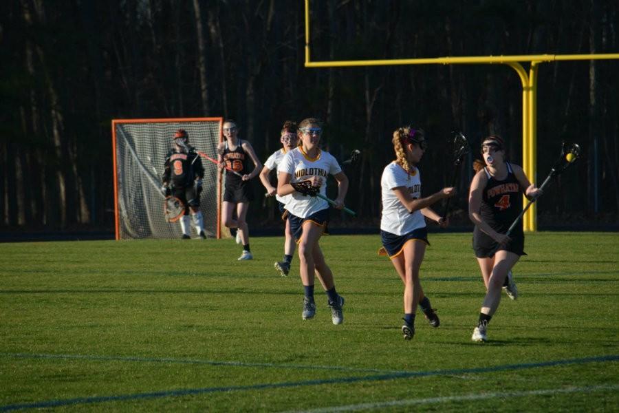 Caroline Wilkes puts on the heat as a girl tries to take the ball down the field.