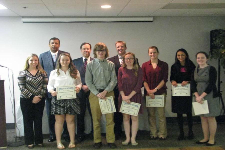 Midlothian students Malia Wing, Austin Van Horn, Madeline Dutton, Amber Arnold, Neha Kulkarni, and Kimberly Russell hold up their certificates and stand by Principal Shawn Abel, sponsor Mrs. Warriner, CCPS superintendent Dr. Marcus Newsome, and County Administrator Mr. Jay Stegmaier. 