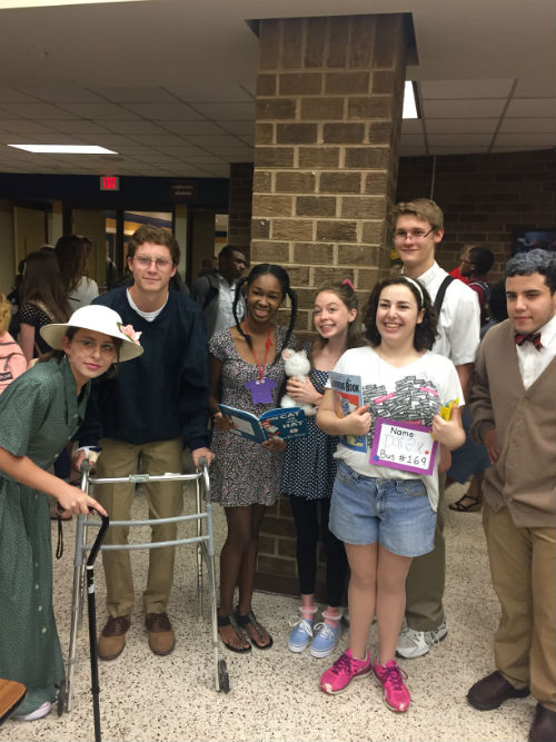 Students pose in the open commons decked out in their senior citizen and kindergarten outfits. 