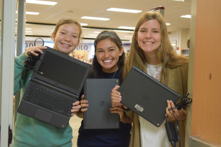 (left to right) Sophia Kopidis, Bella Urcia, and Ellen Tucker excitedly show off their Chromebooks. 