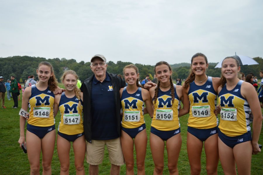 Cross Country ladies show their excitement with Coach Morgan following the race.