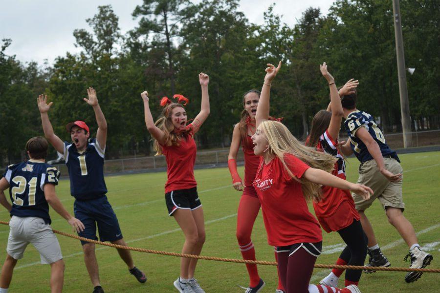 Sophomores celebrate after defeating the seniors in the tug of war game. 