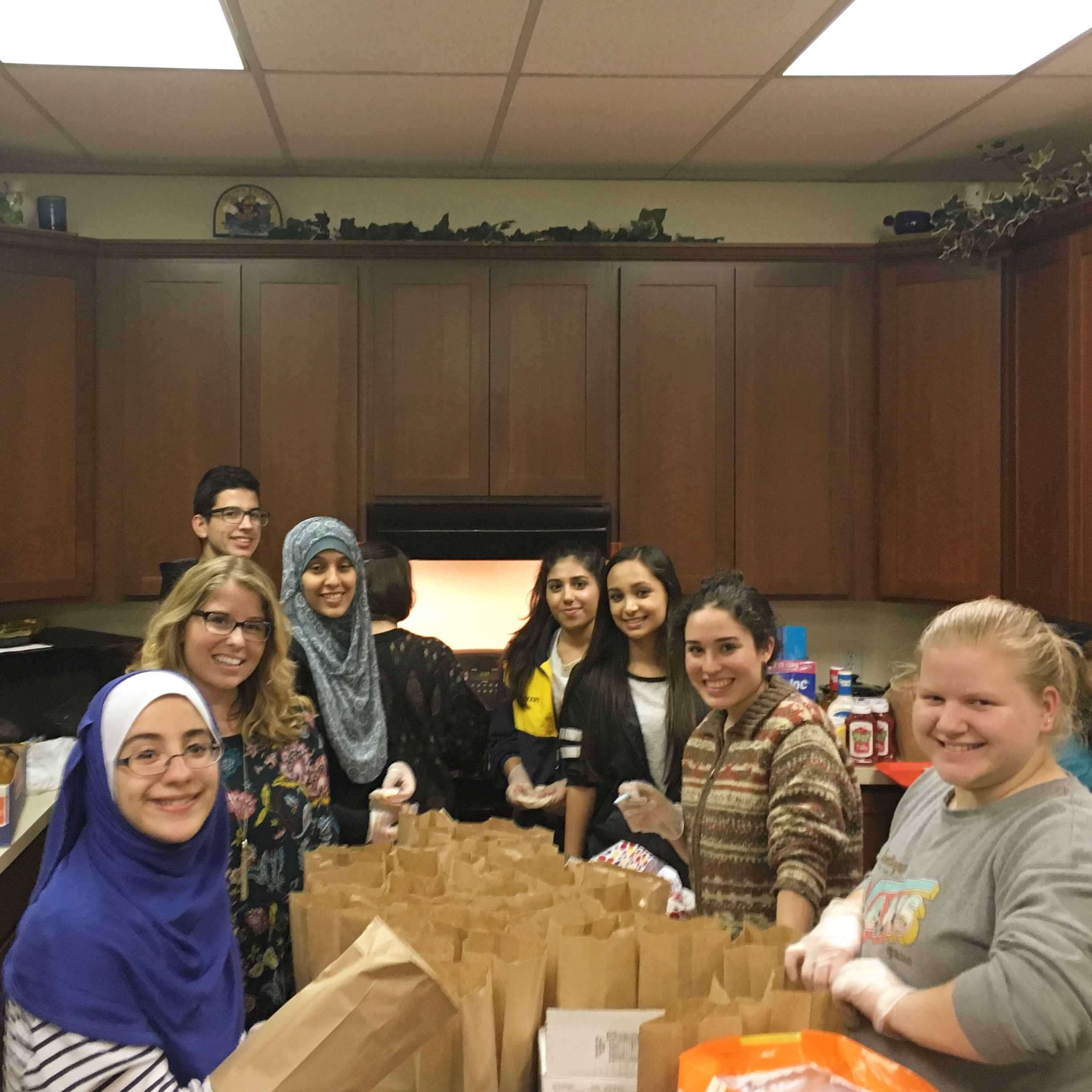 Members of Midlo's World Religion and Tolerance Society, along with their sponsor, Ms. Brooke Rekito, volunteer to benefit CARITAS.