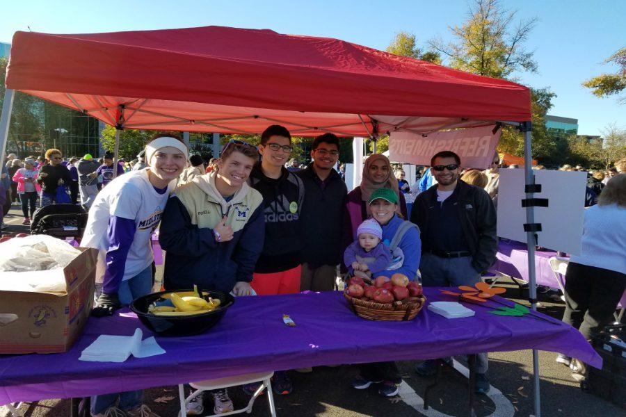 MADA Club members give out various breakfast foods to participants in the walk. 