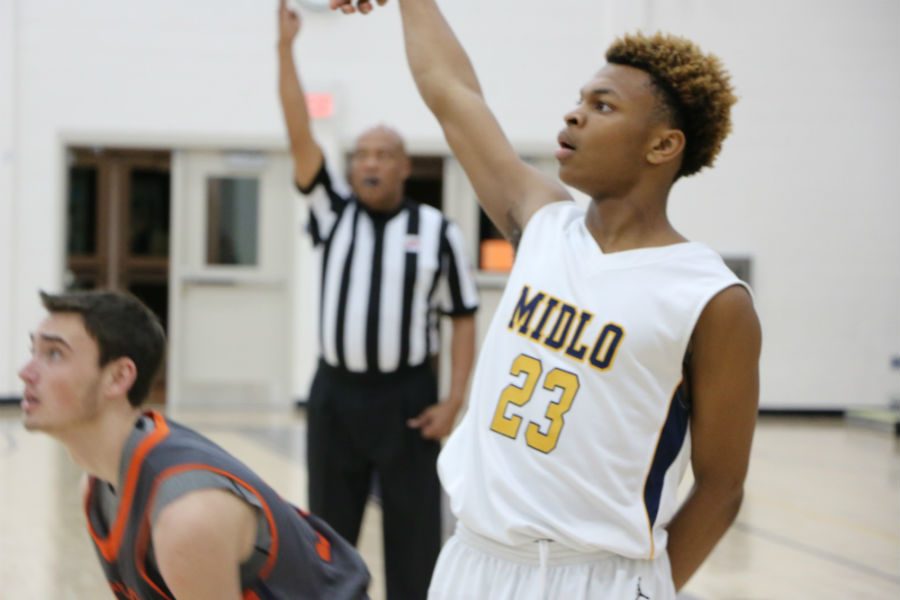 Rico Coleman follows through on a three-point shot.