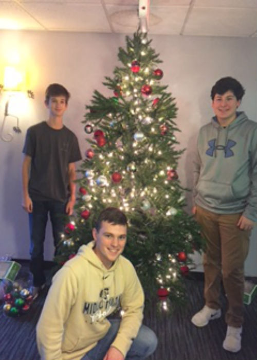 Luke Manheim and Ryan Klaiber adding a little holiday spirit to the Doorways by putting up a nicely decorated Christmas tree.