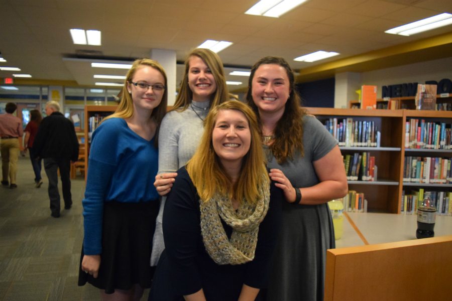 Emily Junkmann, Sydney Van Horn, and Michaela Nadeau spend time after the induction with NEHS sponsor Mrs. Hill. 