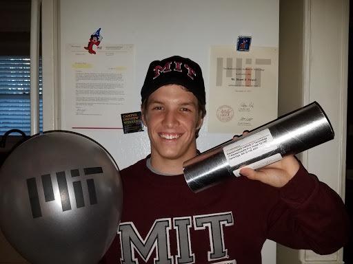 Dillon Powell shows off his MIT gear and acceptance letter. 