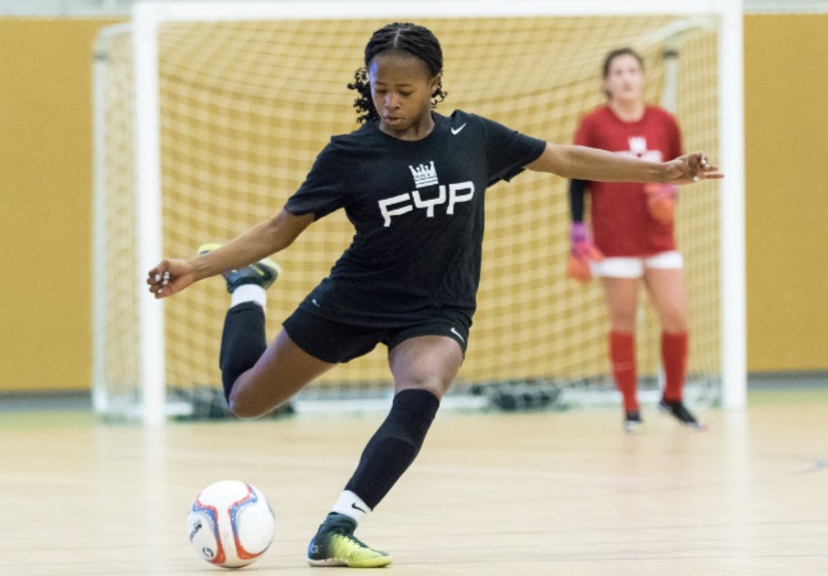 Taylor Shell shoots the ball during a futsal game. 