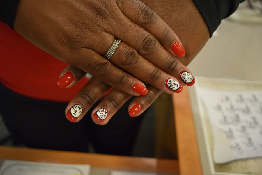 Midlos library secretary shows off her Thing 1 and Thing 2 nails as students enter the library. 