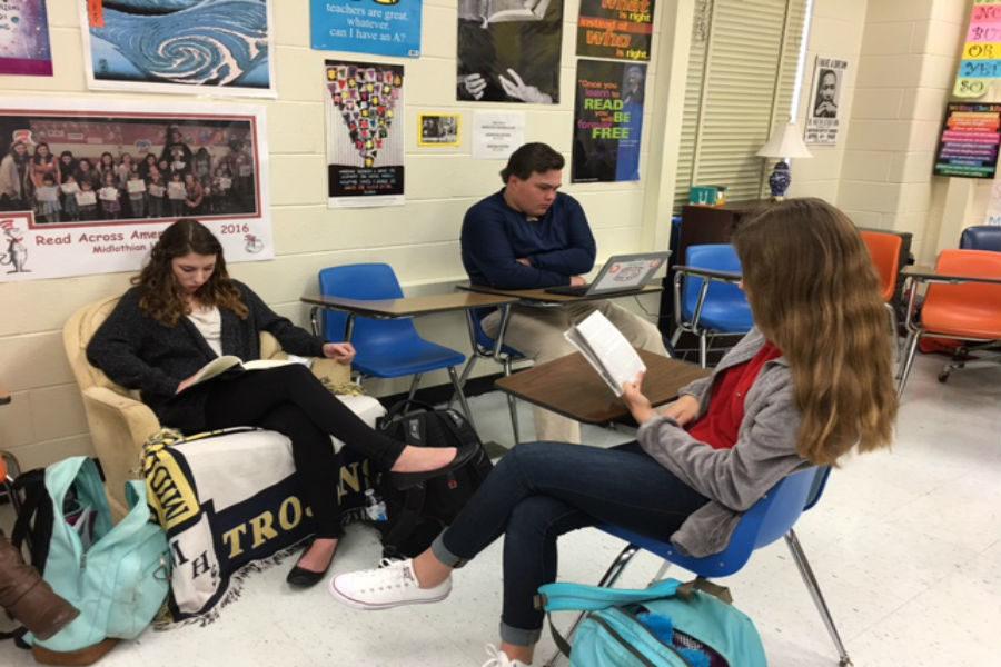 Midlothian High School students Ellen Tucker, Adam Olsen, and Megan Merillat take part in the reading initiative on Read Across America Day.