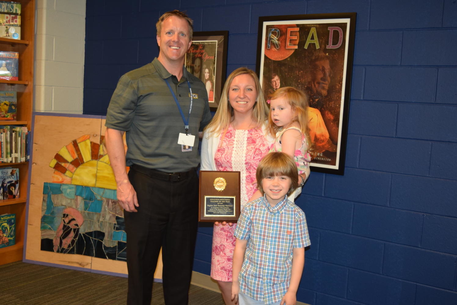 Midlo Principal Shawn Abel congratulates Midlo Teacher of the Year Mrs. Regina Warriner, joined by Jane and Benjamin.