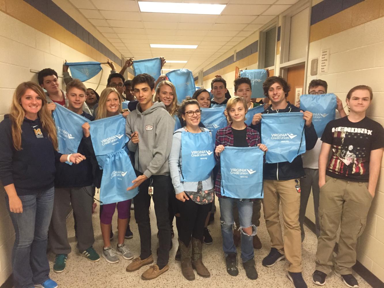 Ms. Kramer's class shows off their drawstring bags from Virginia Credit Union.