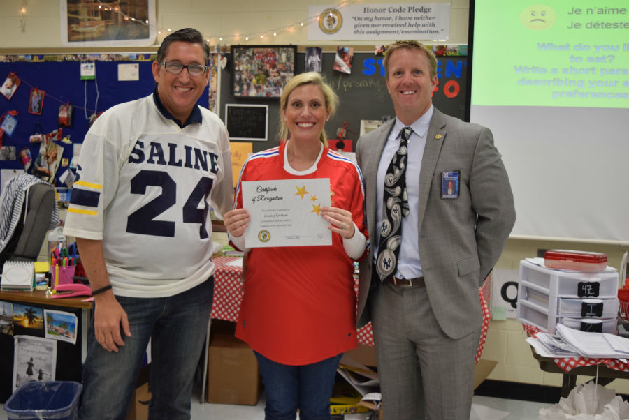 Madame Garrison recieves her certificate for June Employee of the Month.