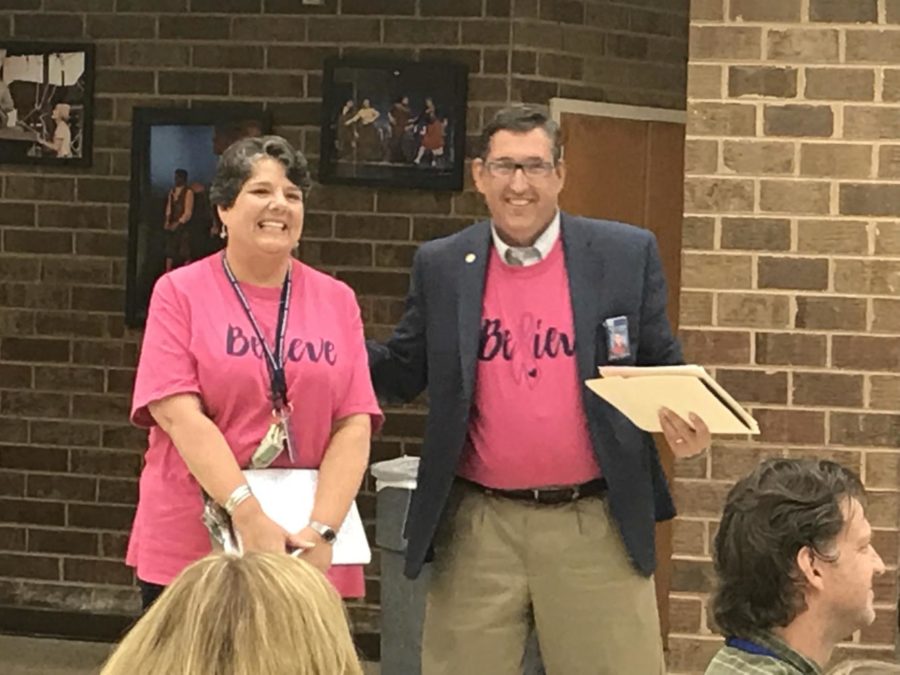 Mr Gifford awards Mrs Gouyer with the Employee of the Month award.