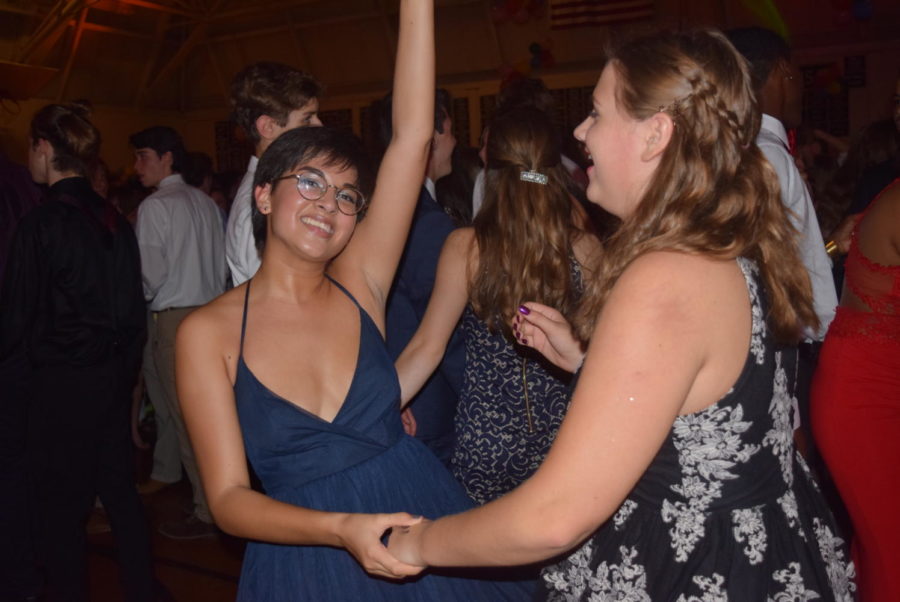 Emma Rice dances to the music with Mollie Jones during the Homecoming Dance.