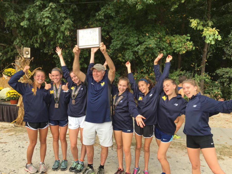 Coach Stan Morgan celebrates as Midlo girls placed first in the Great American XC race in Cary, NC, on October 7, 2017.