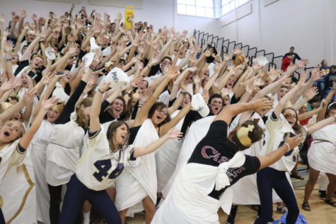 Seniors do the wave during the homecoming pep rally.