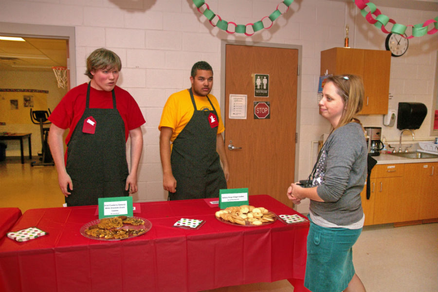 Mrs. Randrianasolo helps her students organize their sweet treats. 