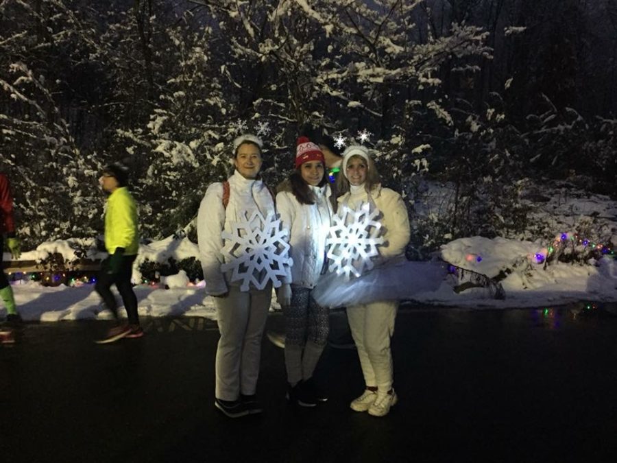 Runners stand out dressed in all white snowflake costumes, including Mrs. Michele McMullen (right), a kindergarten teacher at J. B. Watkins Elementary.