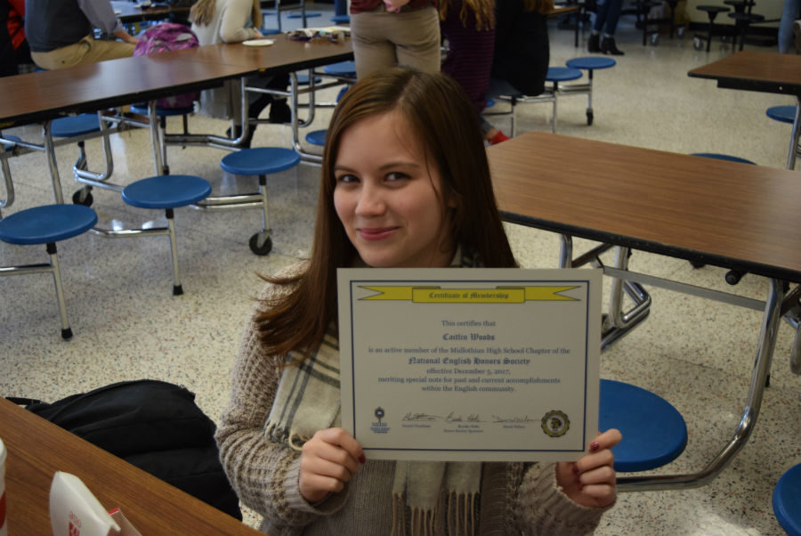 Caitlin Woods shows off her certificate marking her National English Honor Society induction. 