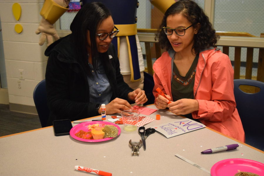 NiAsia Griffin and Hayden Hicks share materials and ideas while designing their cards.