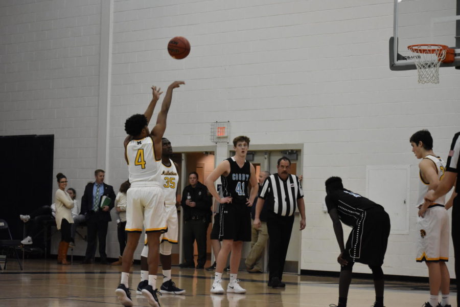 Amir Reid shoots a free throw and scores a point for Midlo.