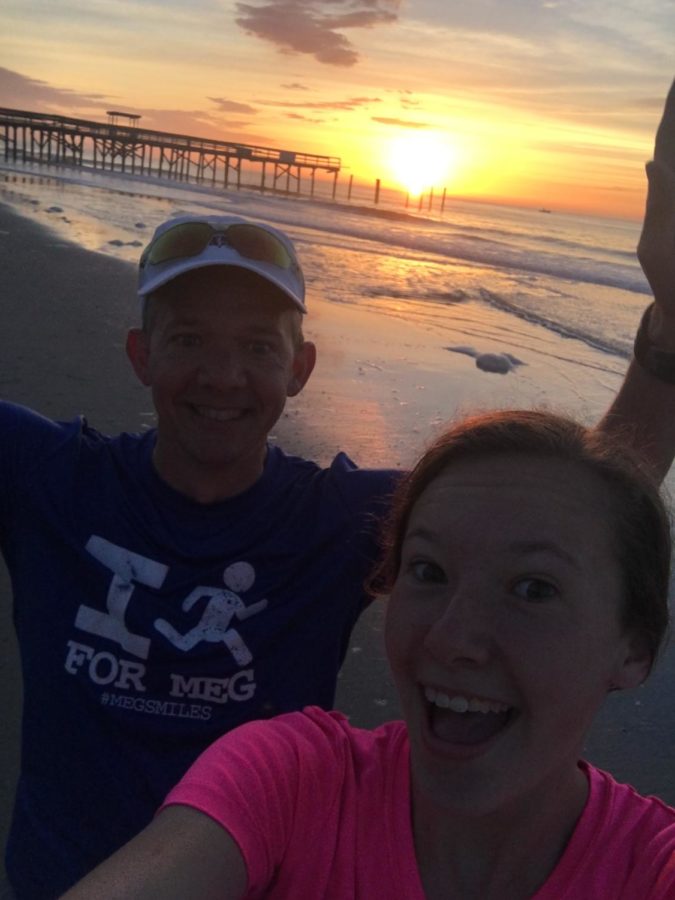 Chloe Martin and Gary Martin watch the sunrise as they finish their morning run.