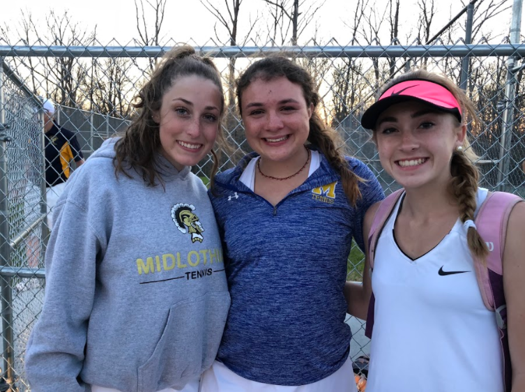 Abby Lamere, Ashley Peterson, and Julia Deaver celebrate the singles and doubles match winners.