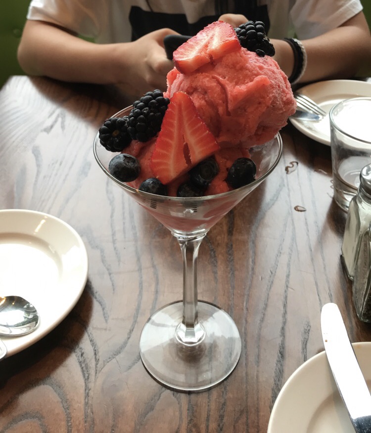Enjoy homemade strawberry sorbet of the day, made with real strawberries, topped with fresh picked berries. 