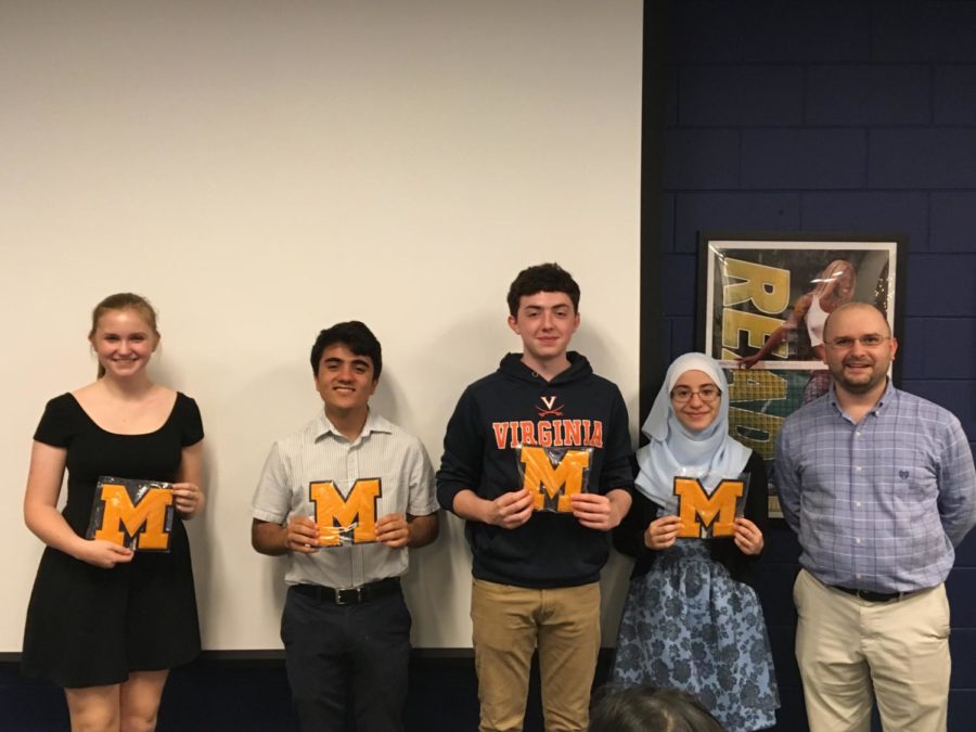 Courtney Galligher, Vincent Mangano, Quentin Phillips, and Nour Goulmamine show off their varsity letters.