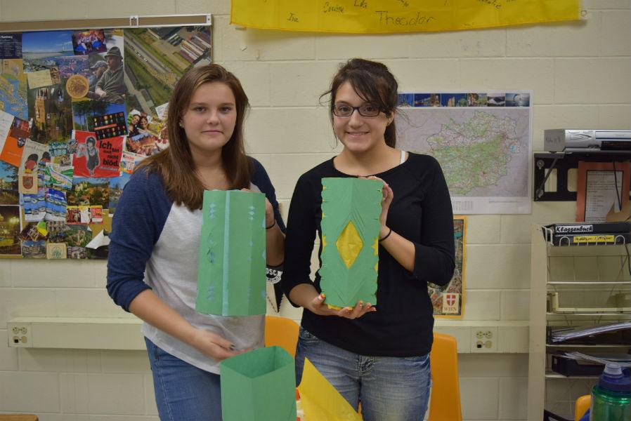 Nora Carlucci and a Tori-Anna Hamilton member make paper lanterns.