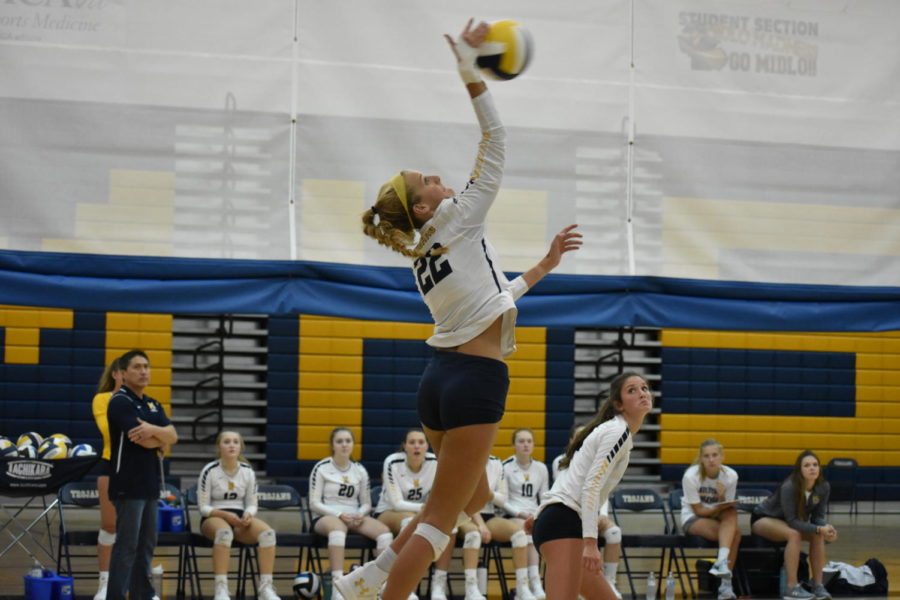 Senior Baylea Botello serves the ball with force over the Powhatans side.