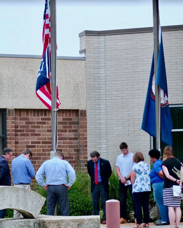 Participants observe a moment of silence for the lives lost during the 9/11 attacks.