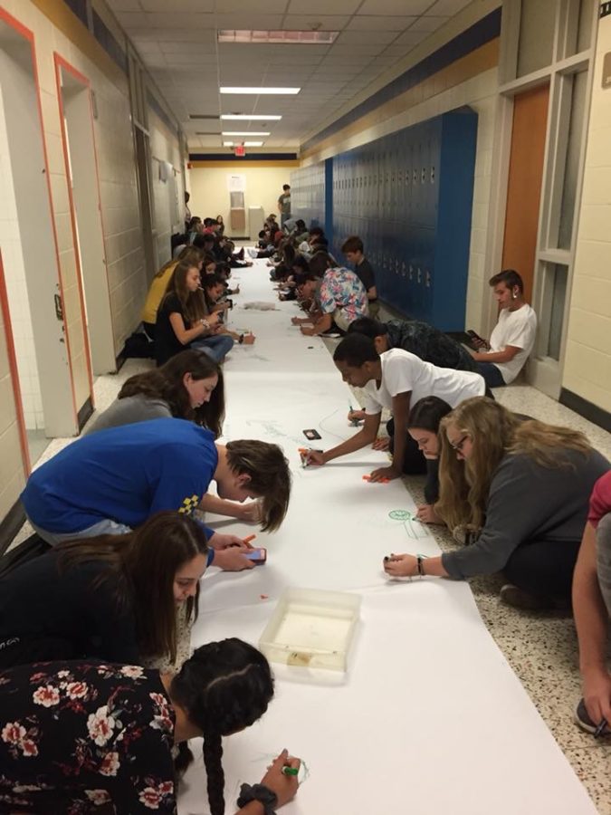 Art students create a giant banner during the tornado.
