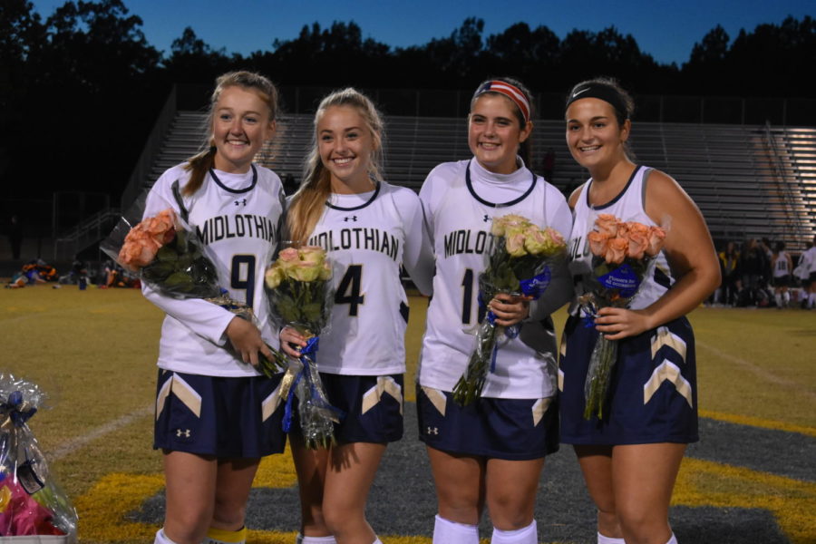 Seniors+gather+together+after+being+recognized+for+their+years+of+playing+for+Midlothian+on+Senior+Night.