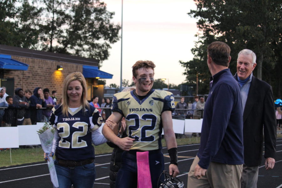 Will Pomeroy enjoys Senior Night with his family at Midlos final home football game.