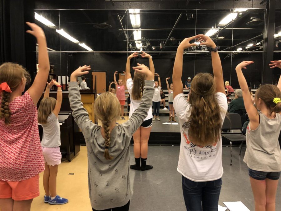 Senior Choreographer Sydney Barefoot demonstrates proper technique for the munchkins.