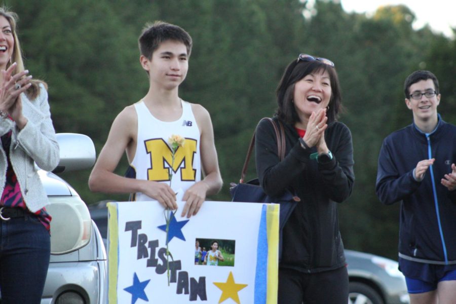 Tristan Smith and his mother celebrate senior night with a handmade poster.