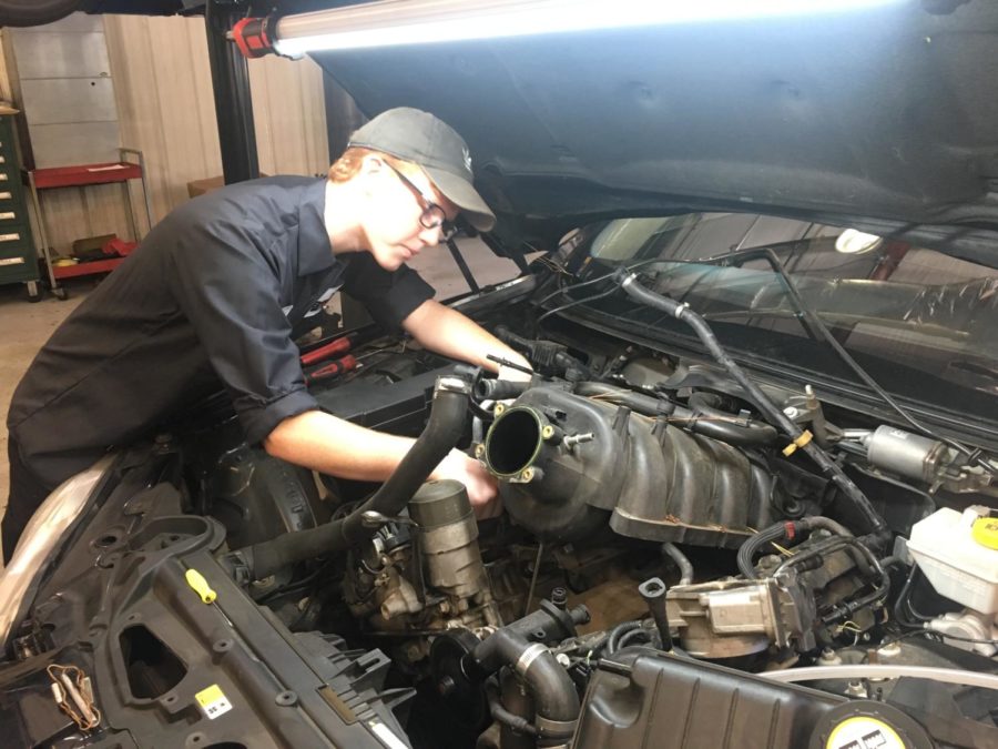 Senior John Kessler repairs cars at Jaguar. 
