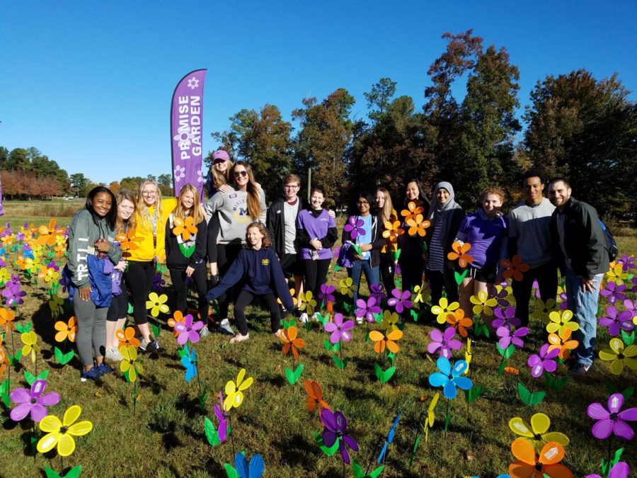 The+Alzheimers+and+Dementia+Awareness+Club+holds+their+flowers+from+the+Alzheimers+Associations+Flower+Garden.