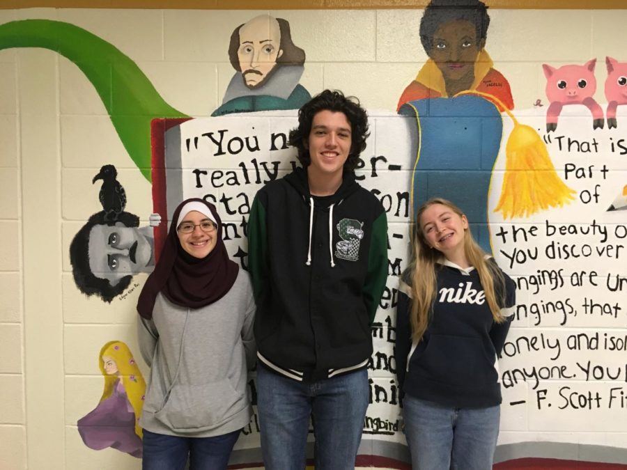 The Writer's Guild officers, Daniel Stein, Britney Price, and Nour Goulmamine, promote their club for the next meeting on November 14th.