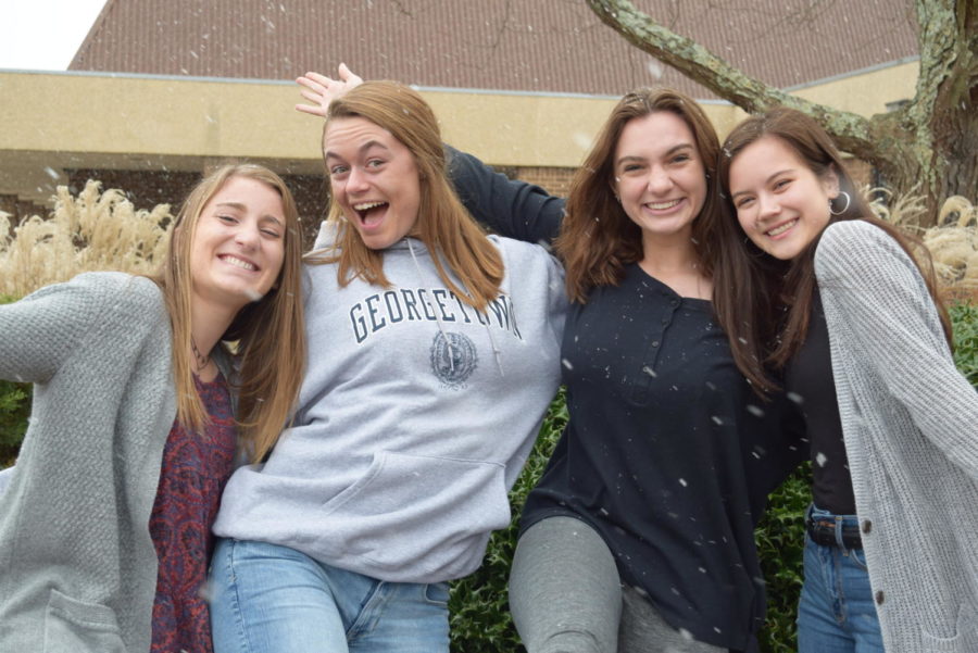 Madeleine Burke, Erin Junkmann, Carrie Rowley, and Caitlin Woods feel excited because snow came during the school day. 