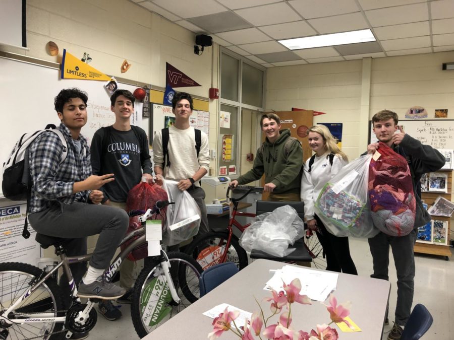 DECA officers prepare to take the Angel Tree gifts to the mall.