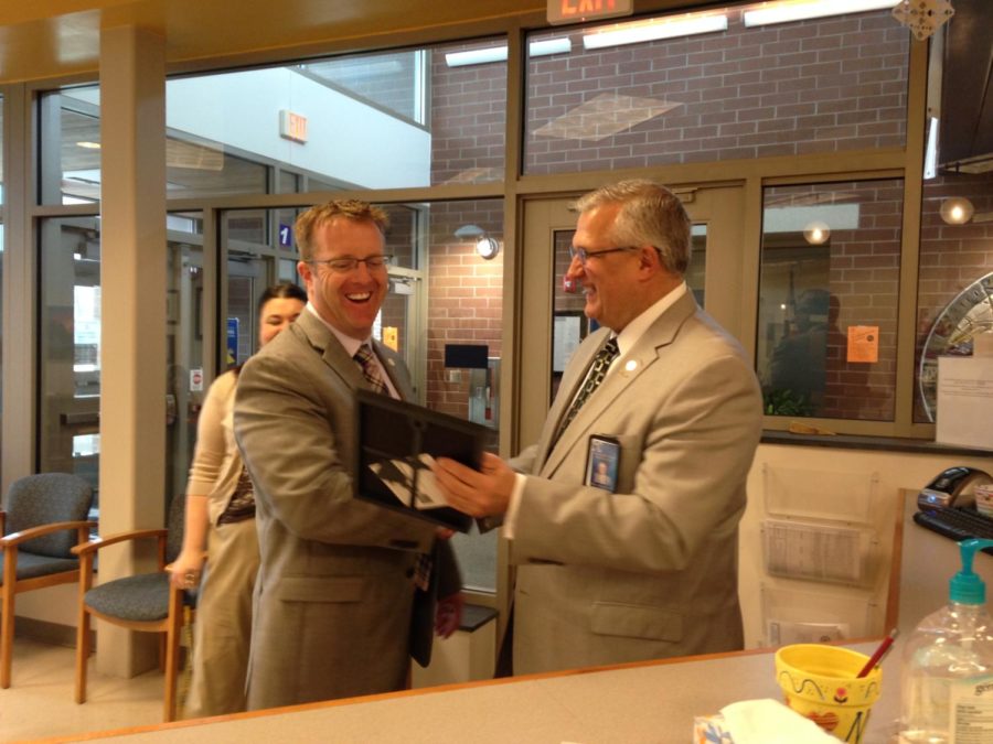 CCPS Superintendent, Dr. Merv Dougherty surprises Midlo Principal Shawn Abel with the Game Changer Award.