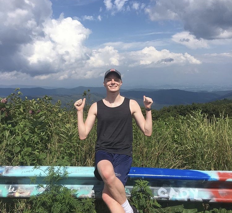 Justin Elliott celebrates his accomplishment of running up a large mountain, Reddish Knob, at Blue Ridge Running Camp 2018.