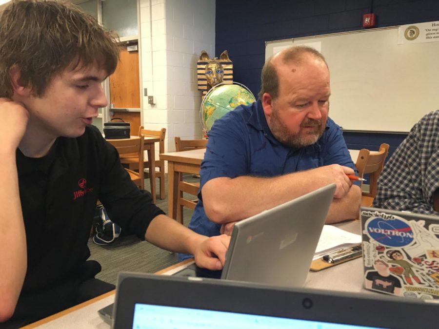 Mr. Donald Wade provides help for Michael Cordova during Oceanography Travel Presentations in the library.