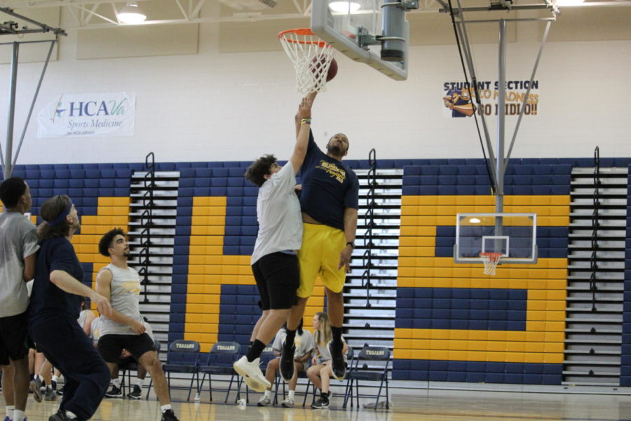 Kaeden Daniels attempts to block Mr. Jarhon Giddings as he jumps up to shoot during the Student vs. Faculty Basketball Game. 