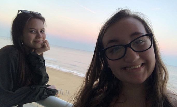 Caitlin Woods and Sarah Moskovitz watch the sunrise from their hotel balcony during spring break 2019. 