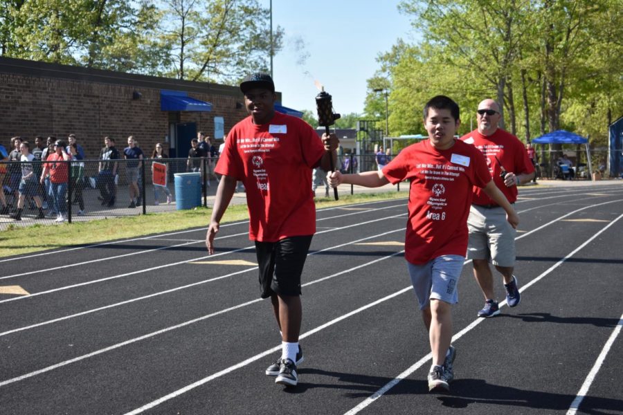 Terrence Reynolds and Danny Huang bring in the ceremonial torch before the 2019 Special Olympics, held at Midlothian High School.